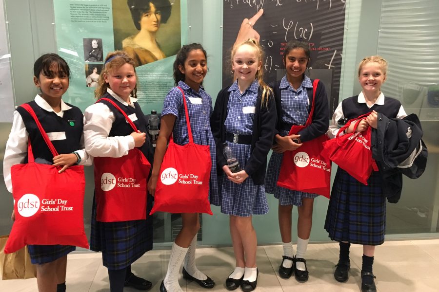 Junior students of Northampton HigH School Carrying red GDST tote bags.
