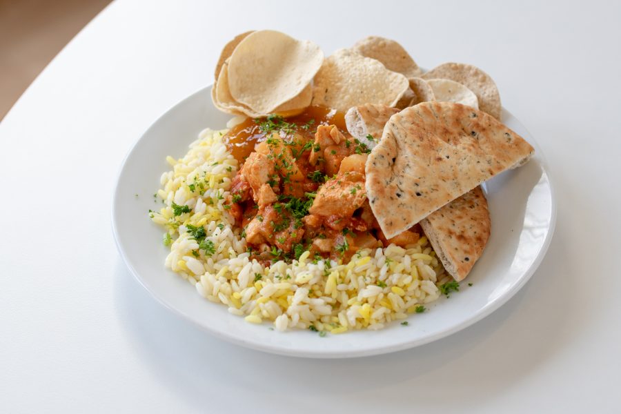 School meal of chicken curry rice and naan bread
