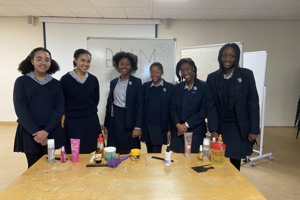 Northhampton High Students attending a hair workshop on protecting and styling Black hair.